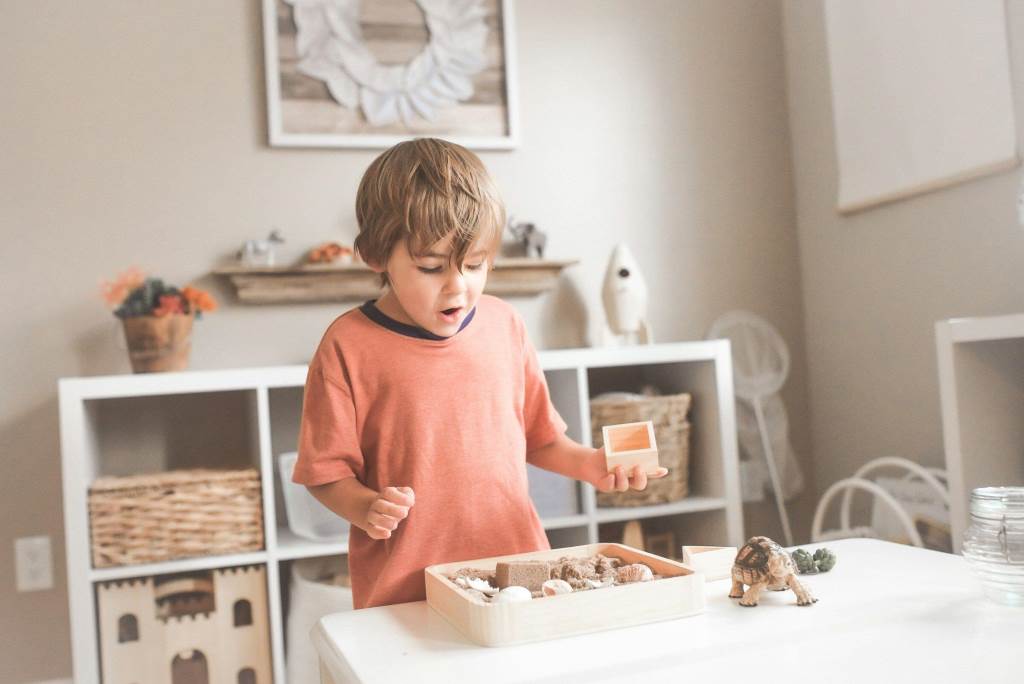 Kids playing with eco-friendly wooden toys in a natural setting