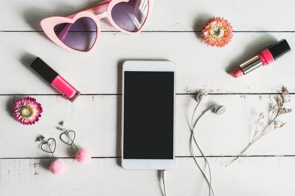 Women cosmetics and fashion items with smart phone