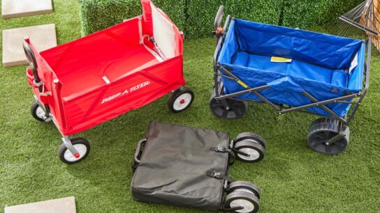 Close-up of collapsible wagon cart carrying umbrellas, towels, and coolers for travel