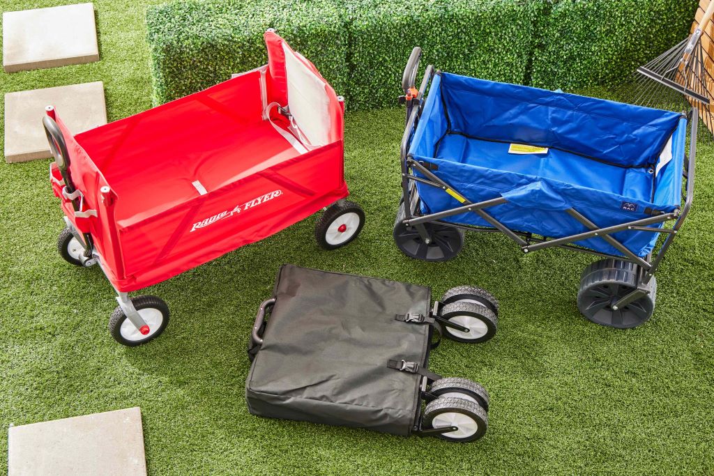 Close-up of collapsible wagon cart carrying umbrellas, towels, and coolers for travel