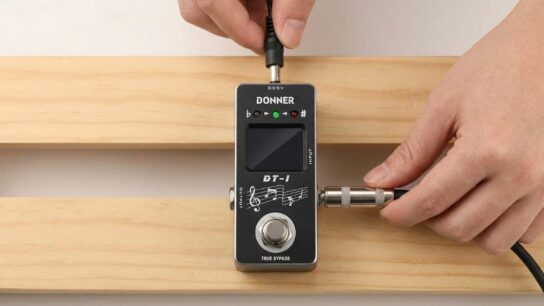Donner DT-1 guitar tuner pedal connected to electric guitar