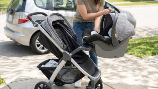 Parent docking Chicco KeyFit infant car seat securely into aluminum Bravo stroller frame.
